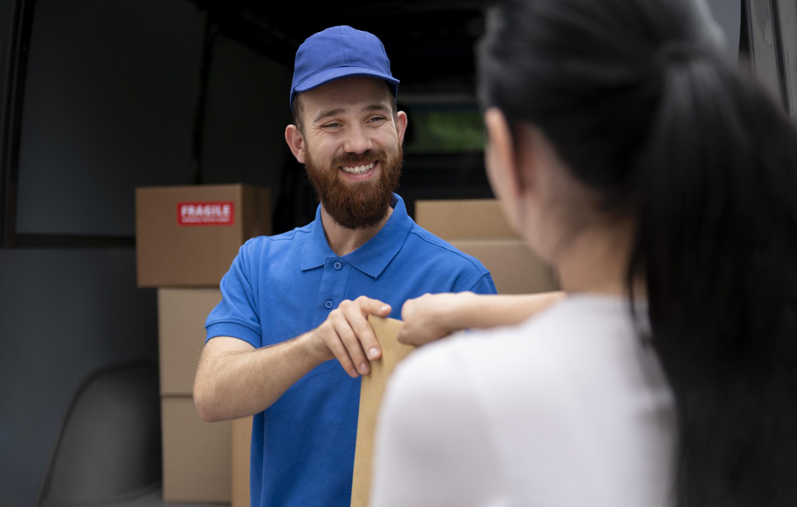 Smiling delivery driver handing a package to a customer