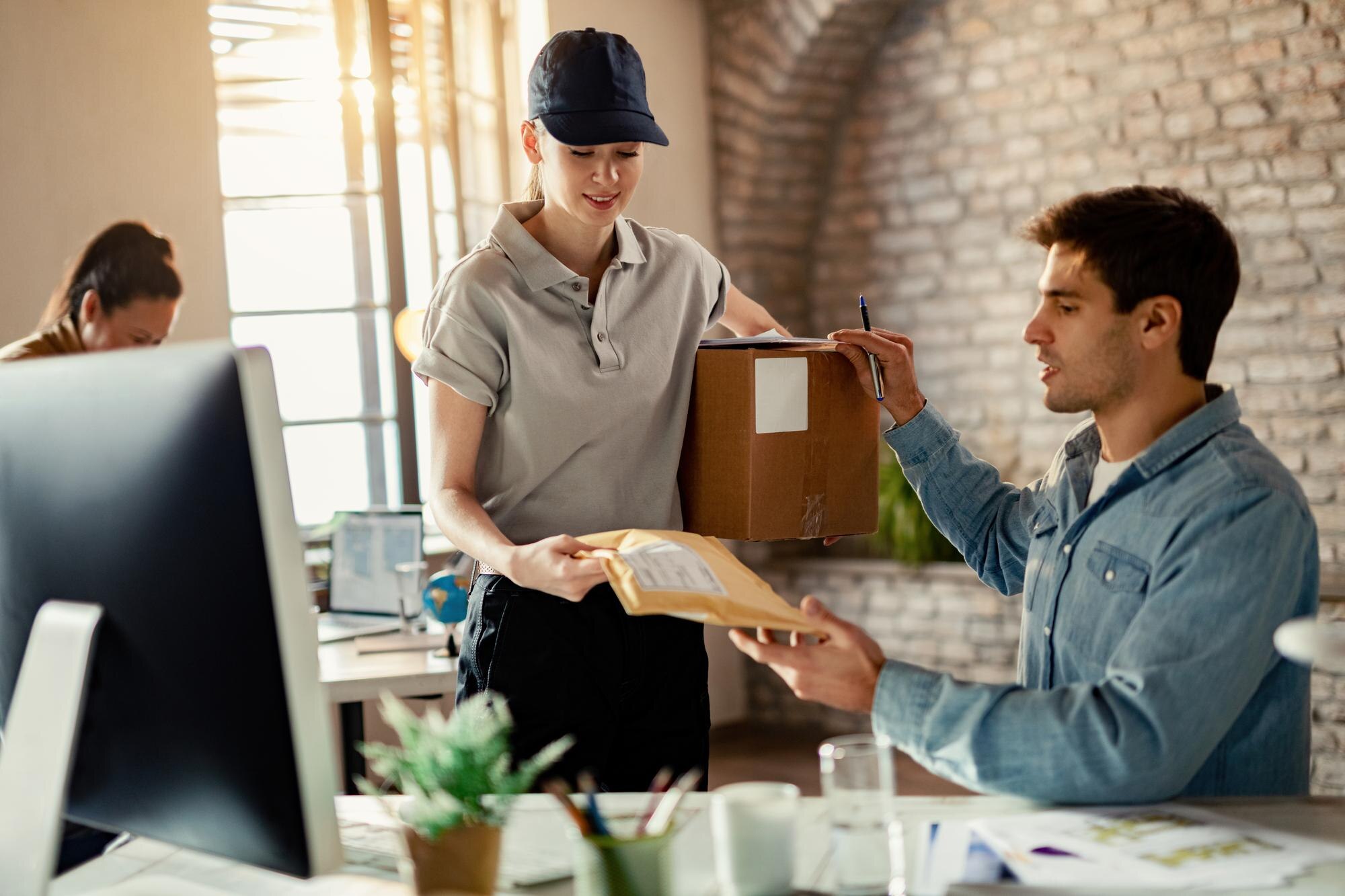 Smiling female courier delivering a package to a customer