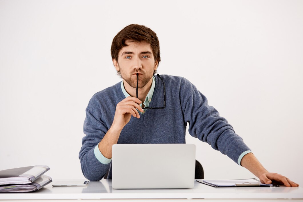 Focused businessman making a quiet gesture while seated